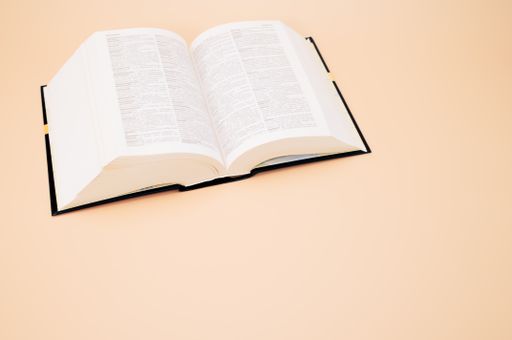 An opened Italian vocabulary book put on a soft cream-colored surface