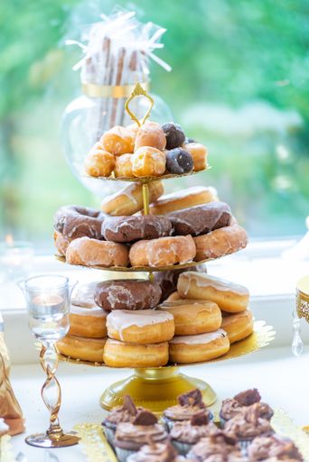A vertical shot of the sweets on the wedding table near the window