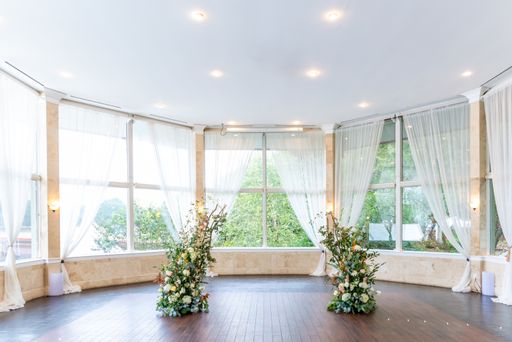 A shot of interior design of the bright area of the wedding hall  decorated with ikebanas