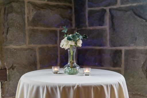 A beautiful shot of a table decorated with candles and white flowers