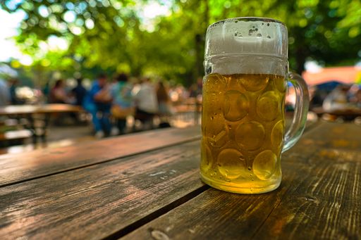 A glass of fresh beer in a traditional bavarian beer garden in Munich, Bavaria, Germany