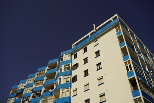 A low-angle shot of a building against the blue sky on a sunny day