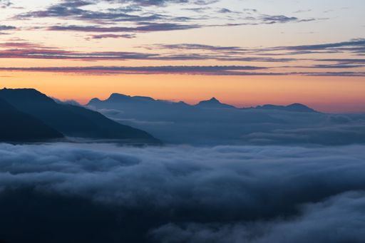 Summer landscape view of a cloud inversion at sunset with a mountain range in the background