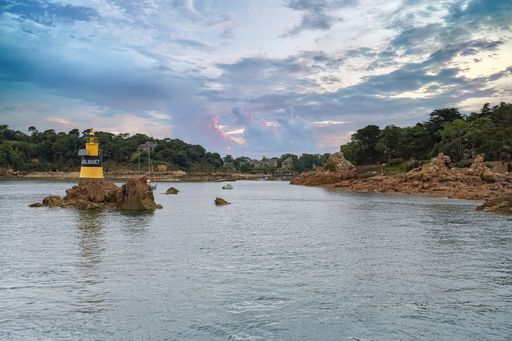Brehat island in Brittany, the yellow Men-Joliguet lighthouse in the harbor