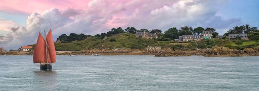 Brehat island in Brittany, a traditional sailing boat, view of the the coastline