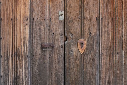 Antique wooden door with rusted hardware