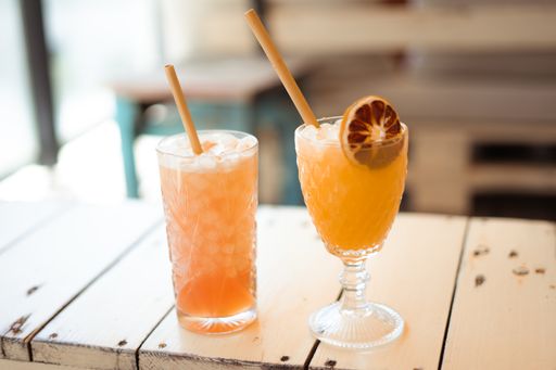 A closeup view of two different cocktails in glasses next to each other on the table