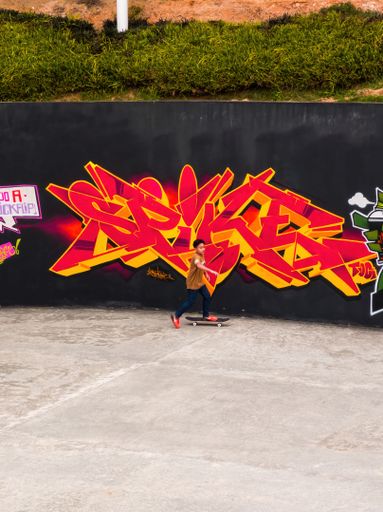 People practicing a trick at a public skatepark in Putrajaya's Taman Cabaran.