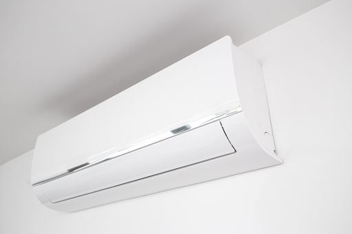 Domestic Air conditioner unit mounted on wall of a modern house