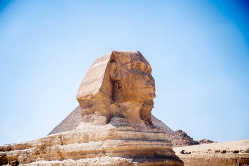 The famous statue of Sphinx in the background of the Great Pyramids, Cairo, Egypt