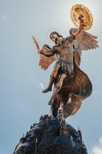 The  statue of Angel protector of Kiev Ukraine under the cloudy sky