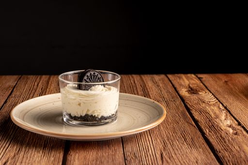 A delicious biscuit with mascarpone on a wooden table