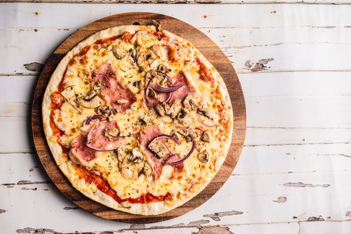 A delicious homemade pizza on a wooden table