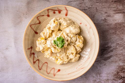 A top shot of cooked pear Fiocchetti on a plate.