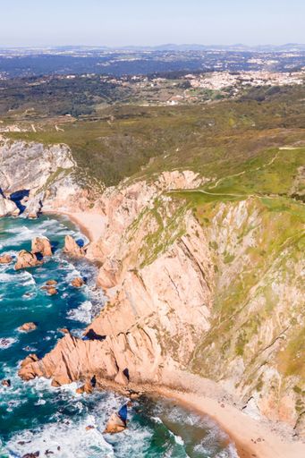 An aerial view of cliffy coastline in Cabo da Roca facing Atlantic Ocean, Colares, Lisbon, Portugal