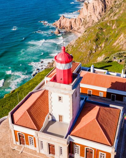 A vertical aerial drone shot of Cabo da Roca in Lisbon, Portugal on a summer day