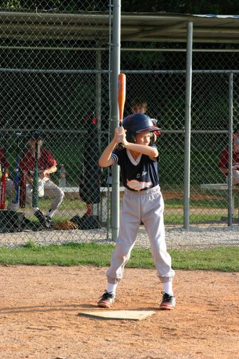 Boy at bat in junior league softball game.