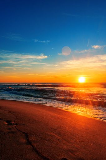 A vertical shot of the North Entrance Beach at sunrise under a blue sky