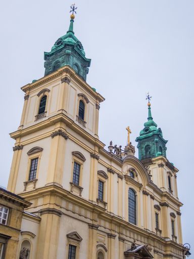 A low-angle shot of the Holy Cross Church in Warsaw, Poland