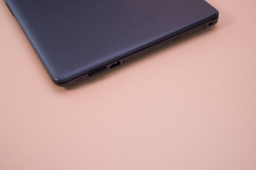 A closeup shot of a closed laptop isolated on a pink background with copy space