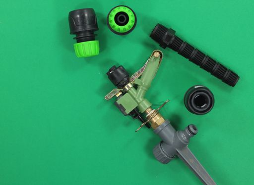 A closeup of garden irrigation accessories hose with fittings
