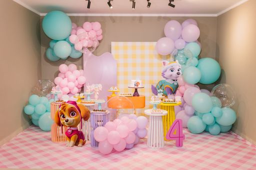 A colorful birthday party setup with balloons and cartoon character decorations, featuring a number 4, indicating the age of the birthday child.