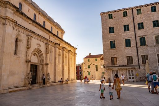 A closeup shot of people standing near the Saint James Cathedral in Sibenik, Croatia