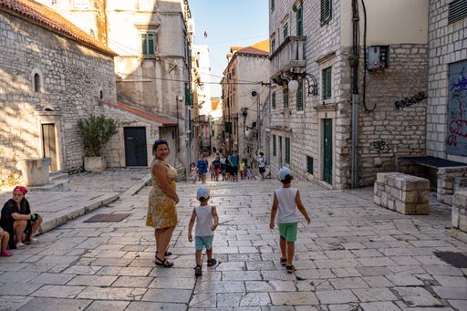 A closeup shot of people standing on a square in the city center of Sibenik, Croatia