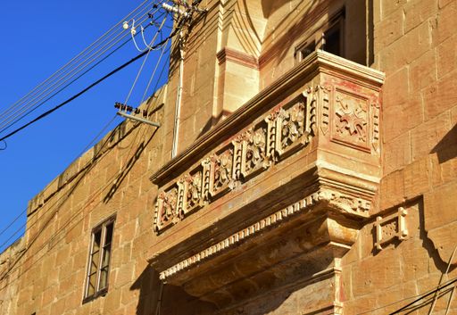 A balcony made of Maltese limestone and decorated with sculpture and stone carving in San Lawrenz