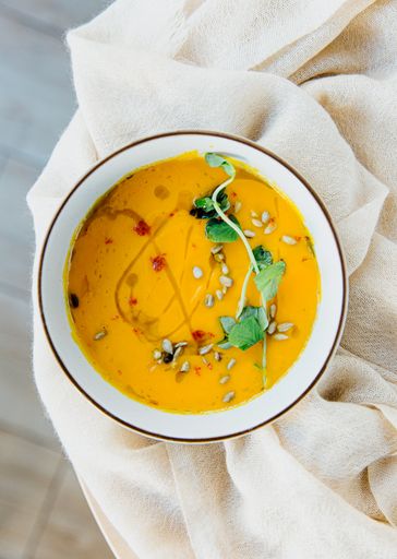 A top view of pumpkin soup in a bowl on a table