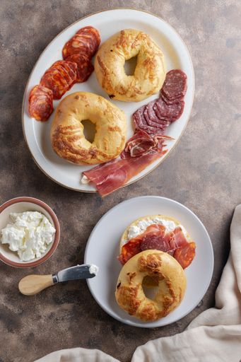 A top-view of crispy bagels with ham, sausages and cream cheese for lunch