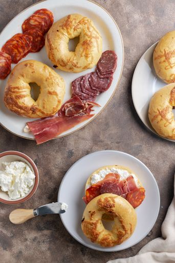 A top-view of crispy bagels with ham, sausages and cream cheese for lunch