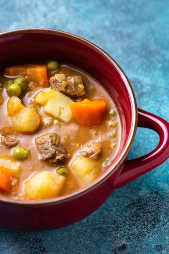 A delicious chickpea and potato curry with beef in a red saucepan