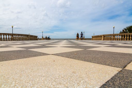 The terrace by the sea in Terrazza Mascagni, Livorno, Italy with a checkerboard floor