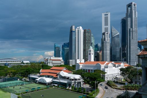 An aerial shot of Padang filed against Singapore Central Business District on a cloudy day