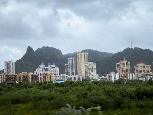A beautiful view of Hong Kong city with mountains in the background and cloudy grey sky