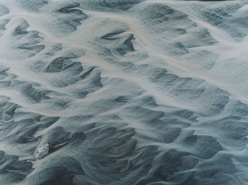 Aerial view of braided river patterns in Iceland, showcasing the natural beauty and intricate design of the landscape.