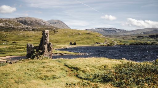 Historic ruins of Ardvreck Castle by the scenic Loch Assynt in Scotland
