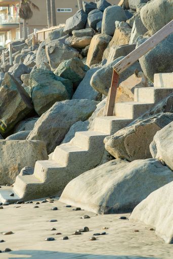 A vertical shot of concrete stairs at a beach during summertime
