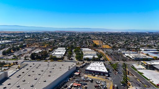 An aerial view of an industrial city area with distant mountains in Fremont captured by a drone.