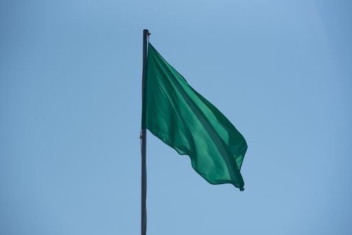A close up of the Green Flag in the Levante beach in Formentera, Spain in summer