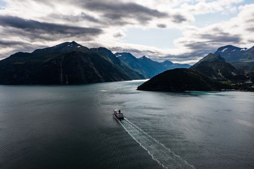 Aerial drone view of a cruise ship, heading towards the Geirangerfjord, in Norway