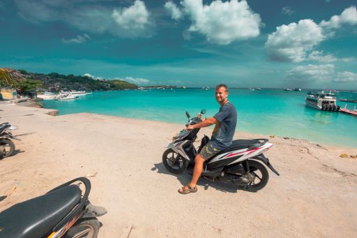 A guy in motorcycle in  surf destination and bars on Nusa Lembongan island off Bali in Indonesia