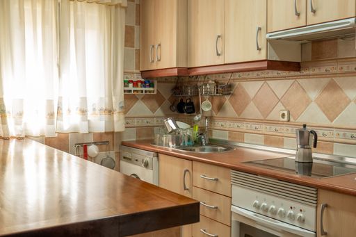 A closeup shot of a furnished home kitchen interior on a bright day