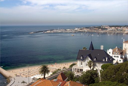 The seascape view and the hotel buildings on the beach of Atlantic Ocean Bay in Cascais, Portugal