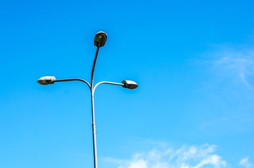 A low angle shot of a street light with a clear blue sky in the background