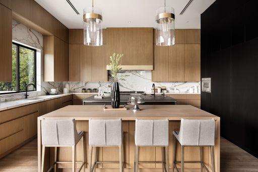 Contemporary kitchen featuring wooden cabinets and marble countertops