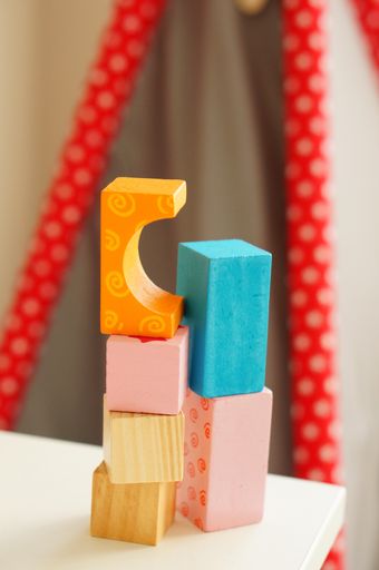 A stack of colorful toy blocks on a wooden table