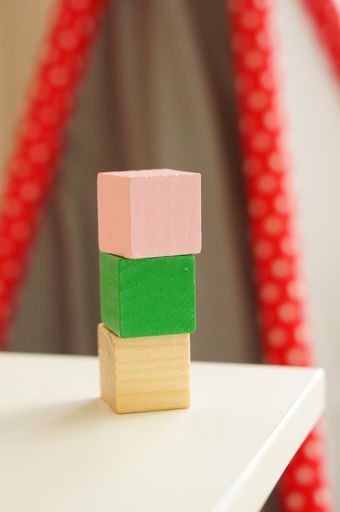 A vertical shot of a pile of wooden blocks on a table with a blurred background