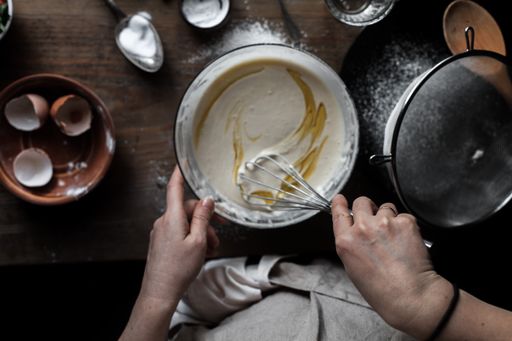 A top view of a woman baking pancakes in the kitchen